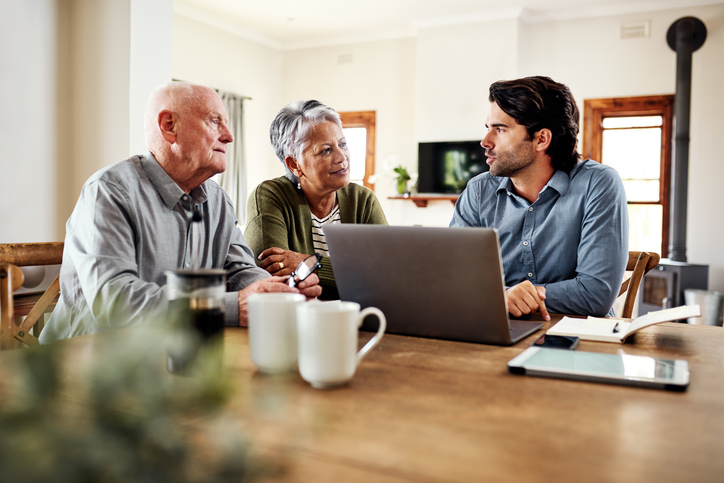 A senior couple discussing mutual fund investments with a financial advisor.