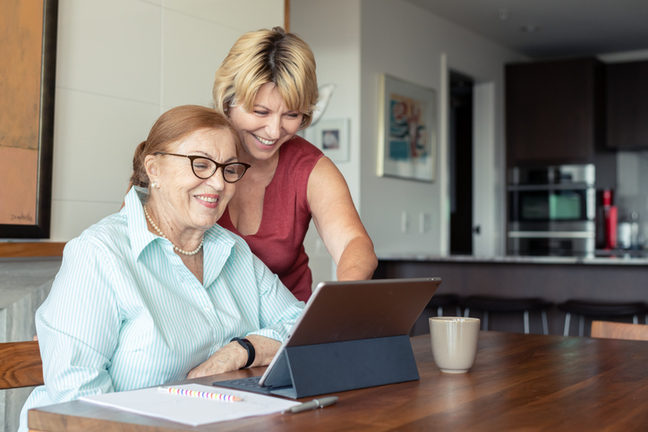 A senior and her daughter reviewing retirement income strategies.
